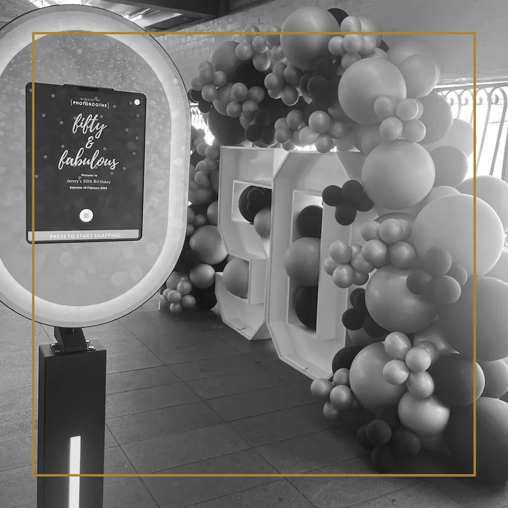 Balloon display with large “50” and a Ministry of Photobooths photo booth screen for a fiftieth birthday celebration.